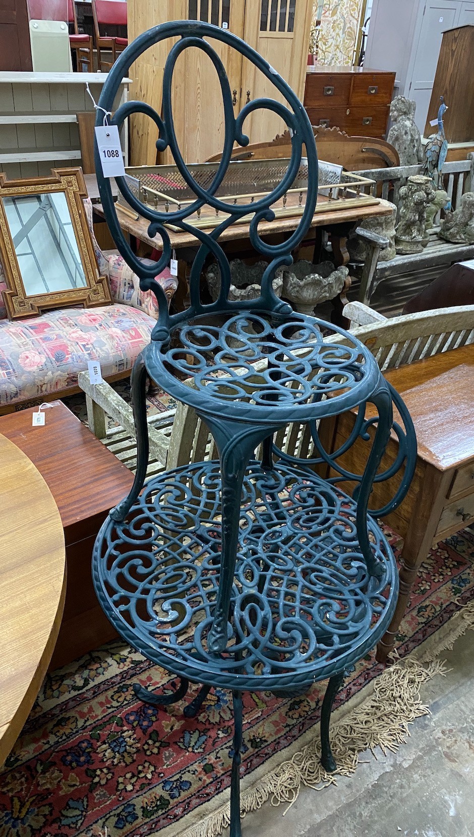 A green painted aluminium cafe table and two chairs